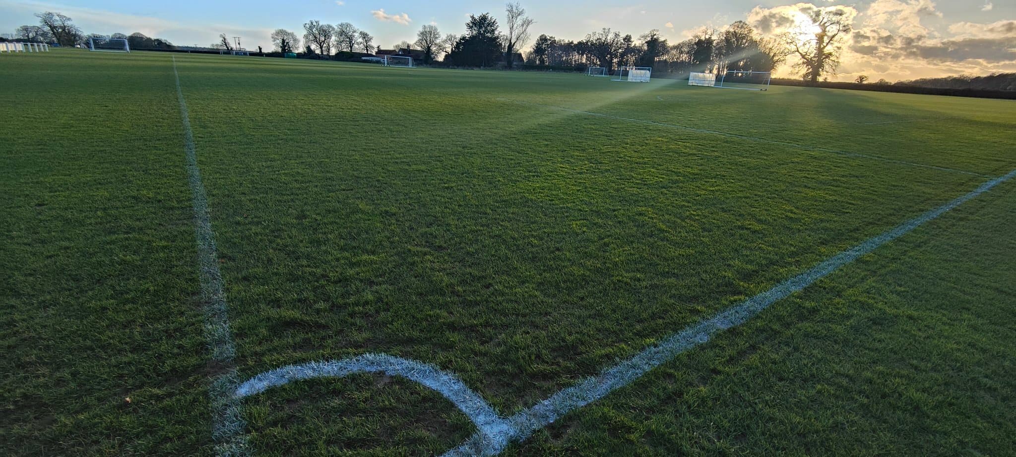 The clubhouse and main pitch at dusk